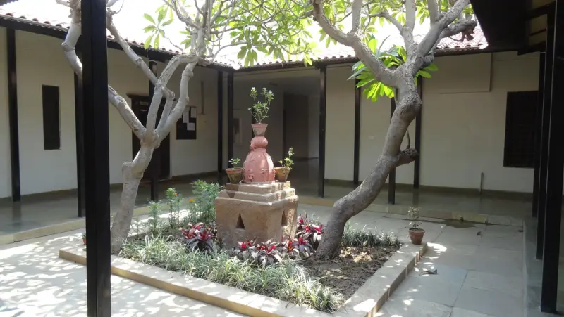 Indian courtyard with tulsi plinth and frangipani